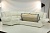 Фото кожаного углового дивана Оберон с откинутыми мягкими подушками подлокотника и открытым для раскладки кроватного механизма Седафлекс